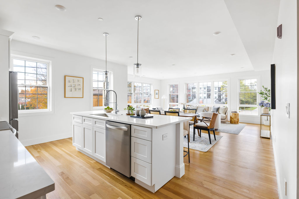 Bright open kitchen with a stunning island, modern fixtures and abundant prep and gathering space.