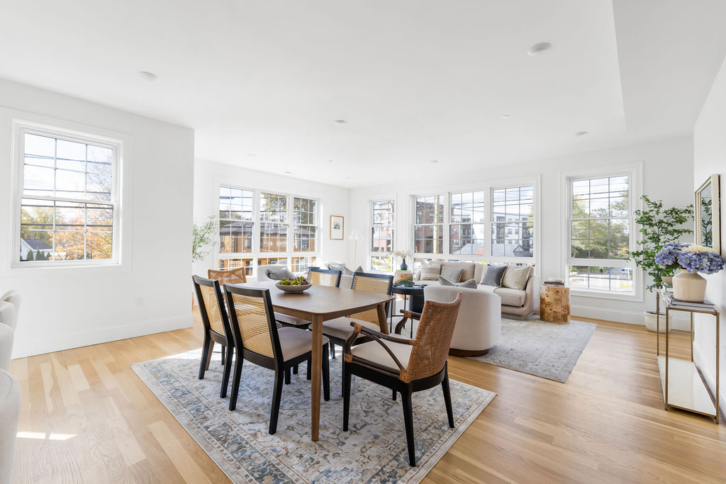 Bright and airy dining area featuring walls of windows, contemporary finishes and beautiful hardwood floors.